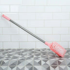 Angled shot of long handle toilet cleaning brush designed for bathroom use