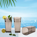 Black square plastic tumblers ideal for serving various beverages.