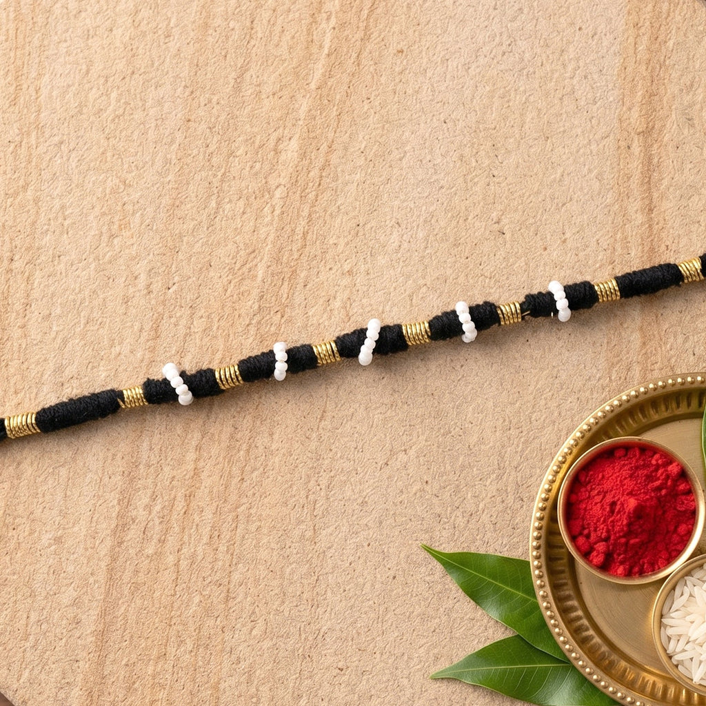 Elegant black thread rakhi with white pearl beads for festivals
