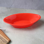 Angle shot of glossy red oval plastic Marin serving bowl
