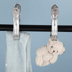MaxClamp stainless steel clothespins holding laundry items firmly.