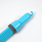Durable plastic broom being used to clean a tiled bathroom floor effectively.