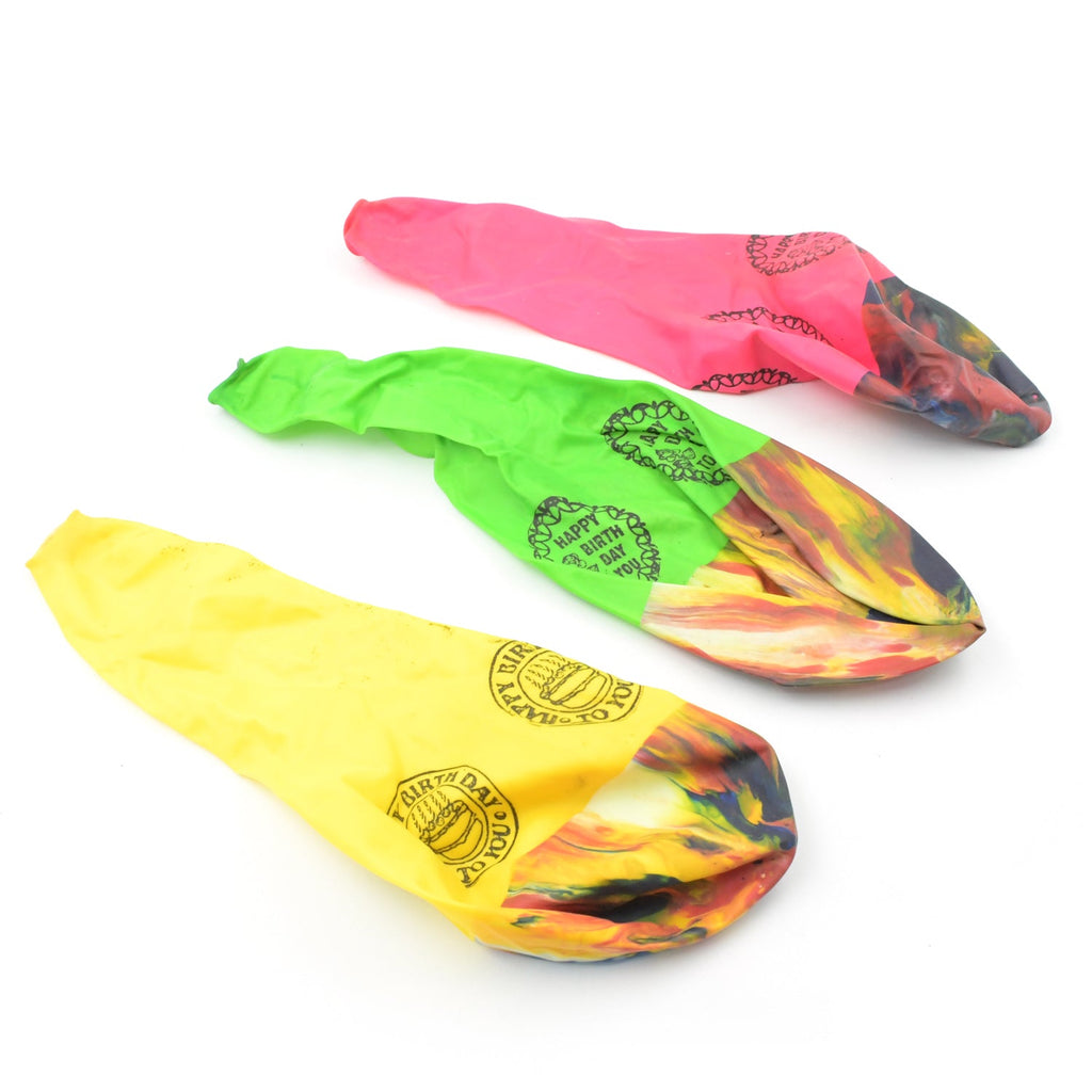 Bright rainbow party balloons scattered on the floor, ready for celebration.
