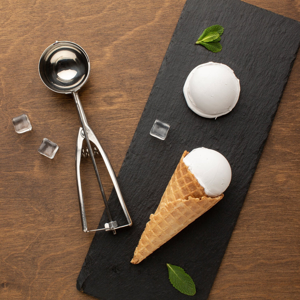 Stainless steel ice cream scoop with trigger release mechanism.