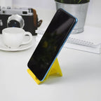 Compact foldable plastic mobile phone stand for desk use