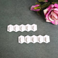 Set of 10 white plastic adhesive wall hooks for drill-free hanging.