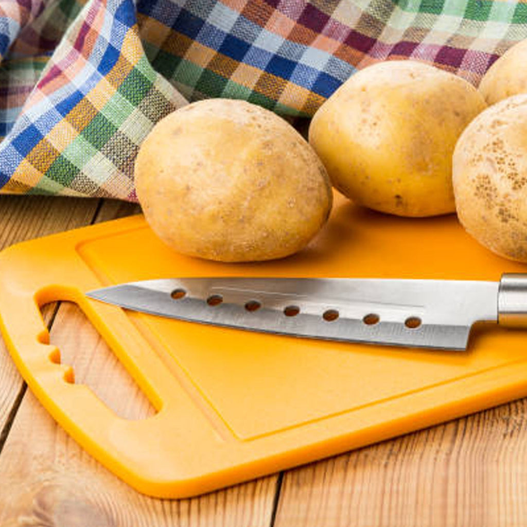 Plastic chopping board positioned on a clean countertop, ready for versatile use.