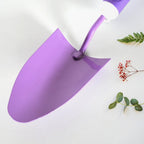 Gardener using the durable trowel from the heavy-duty garden tool kit.
