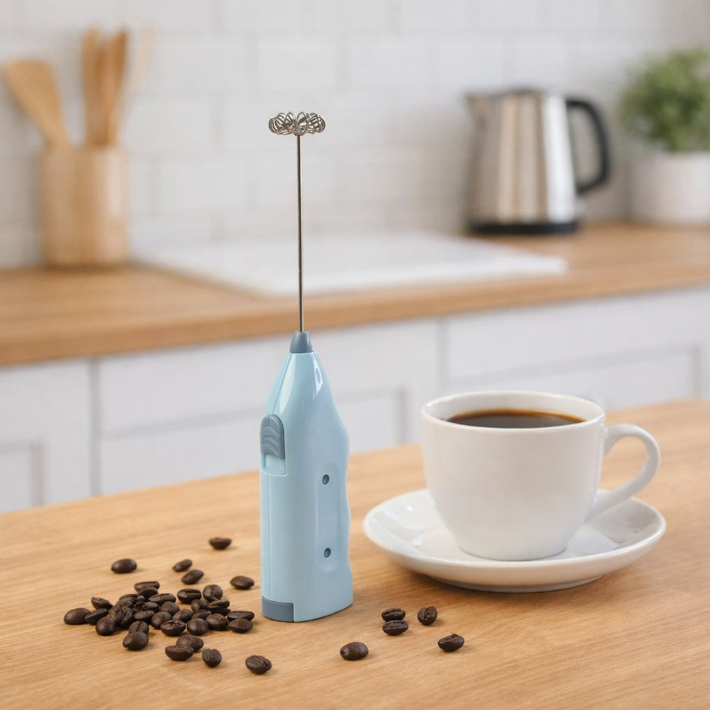 Handheld milk frother blender creating frothy coffee foam