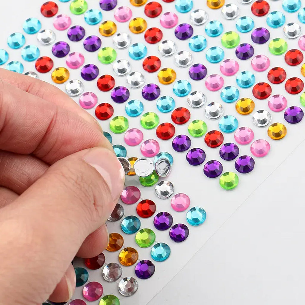 Decorative self adhesive stones arranged for a jewelry making design.
