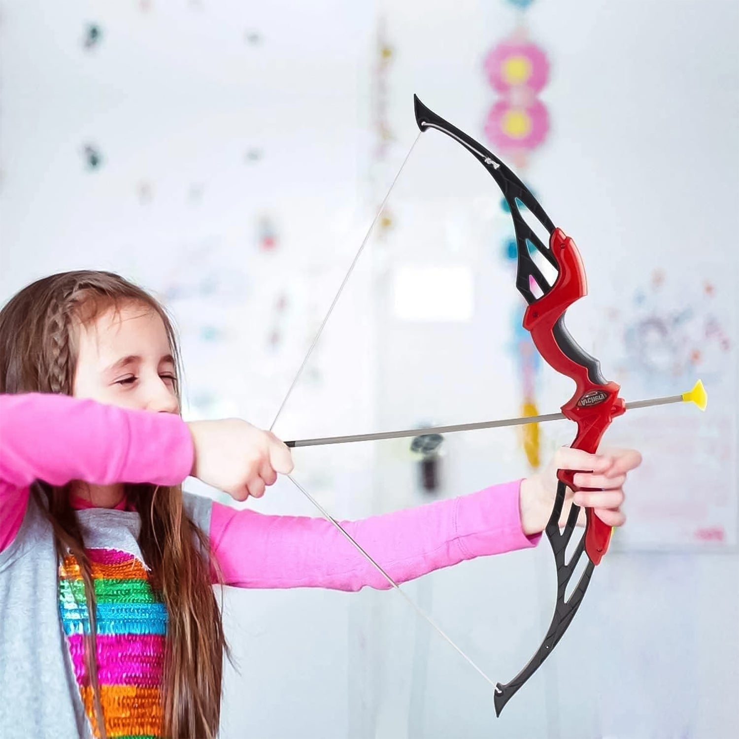 A child enthusiastically aiming the dhanush from the Kids Archery Set, demonstrating improved hand-eye coordination.
