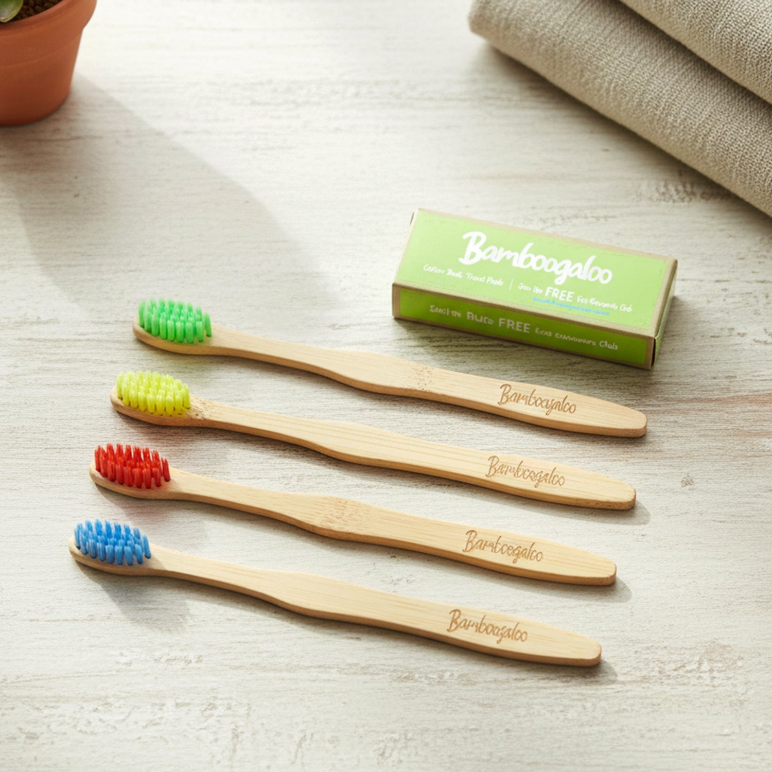 Pack of 4 bamboo toothbrushes for adults with included cotton buds