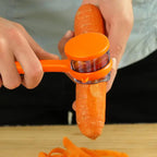 Peeler blade peeling a carrot with container collecting peels