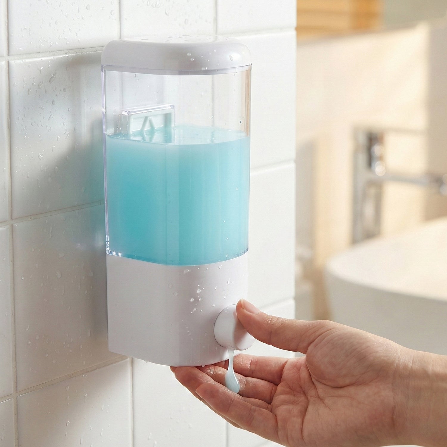 Manual push button liquid soap dispenser mounted on wall