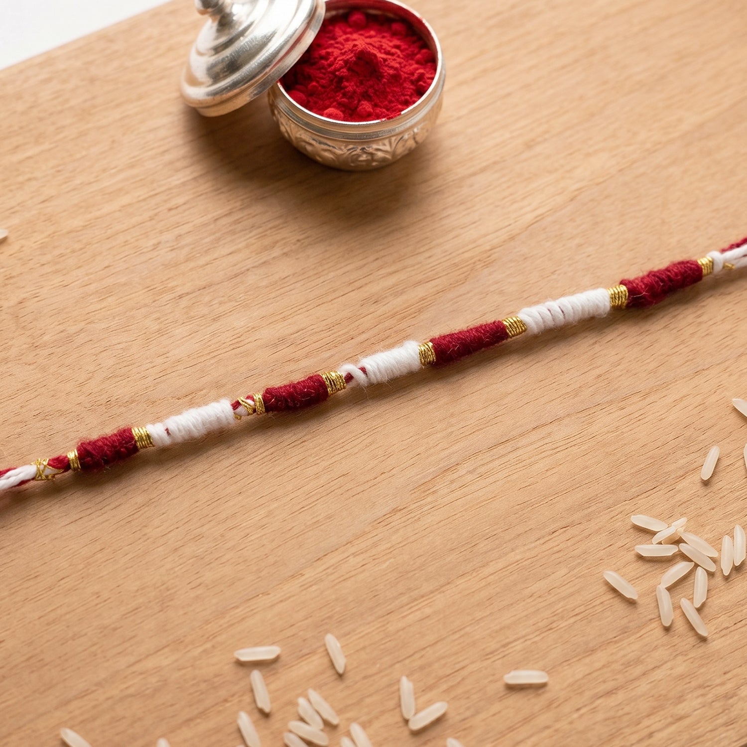 Decorative red and white Rakhi thread bracelet