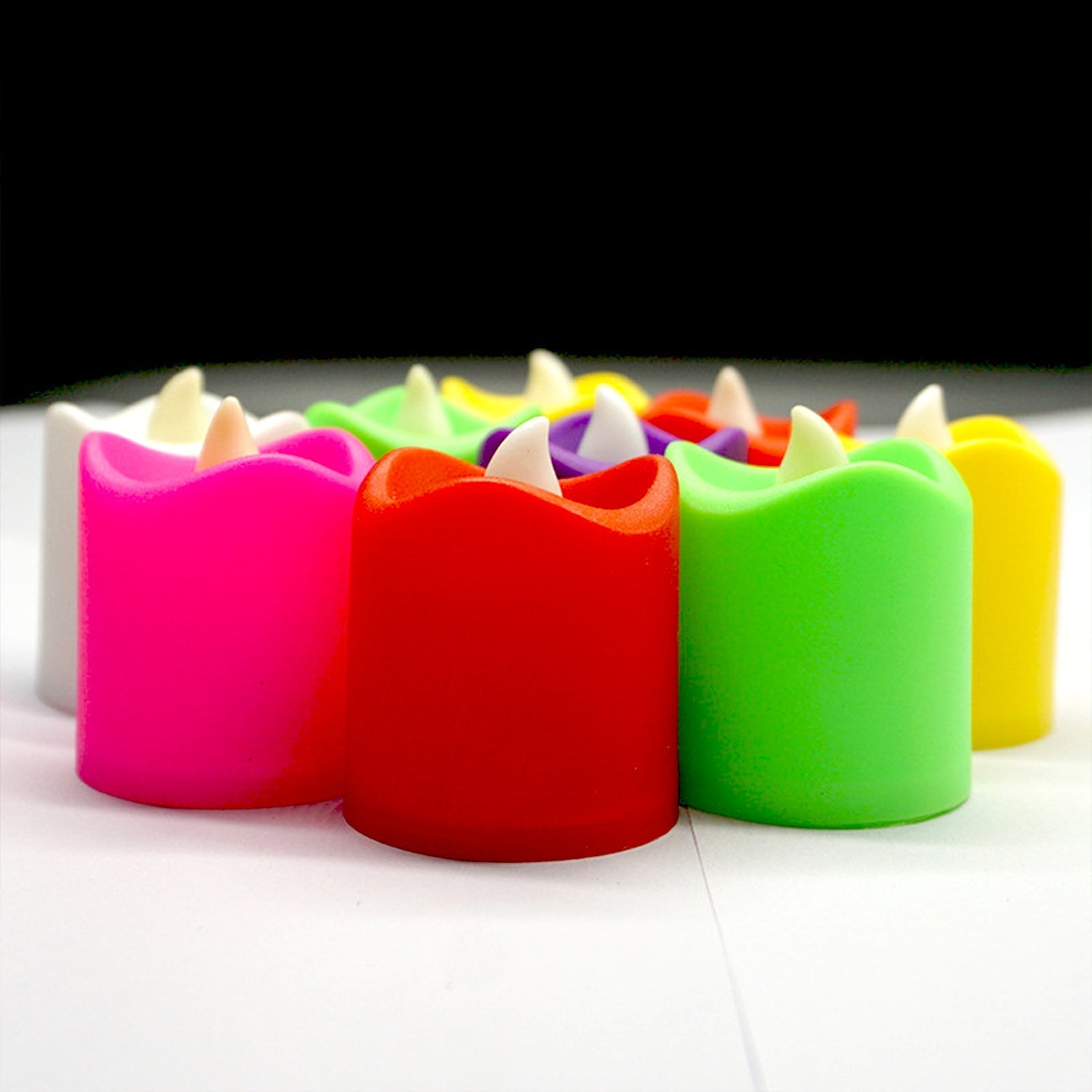 An assortment of bright LED candles in different colors, ideal for party decor.