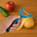 Stainless steel vegetable peeler with a serrated blade, ready for use in the kitchen.