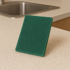 Close-up of heavy-duty scrubber pad used on pan for deep cleaning