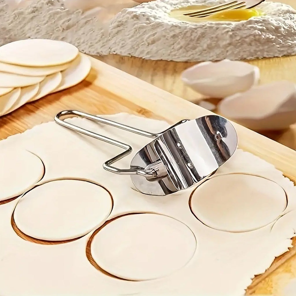 Stainless steel puri cutter roller with comfortable handle on a clean surface.