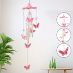Butterfly Bell Wind Chimes swinging gently in a soft outdoor breeze