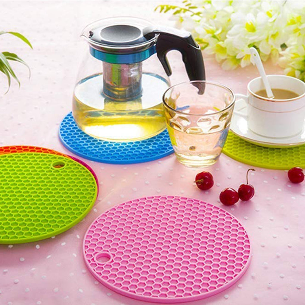 Round heat-resistant silicone trivet with a non-slip design.