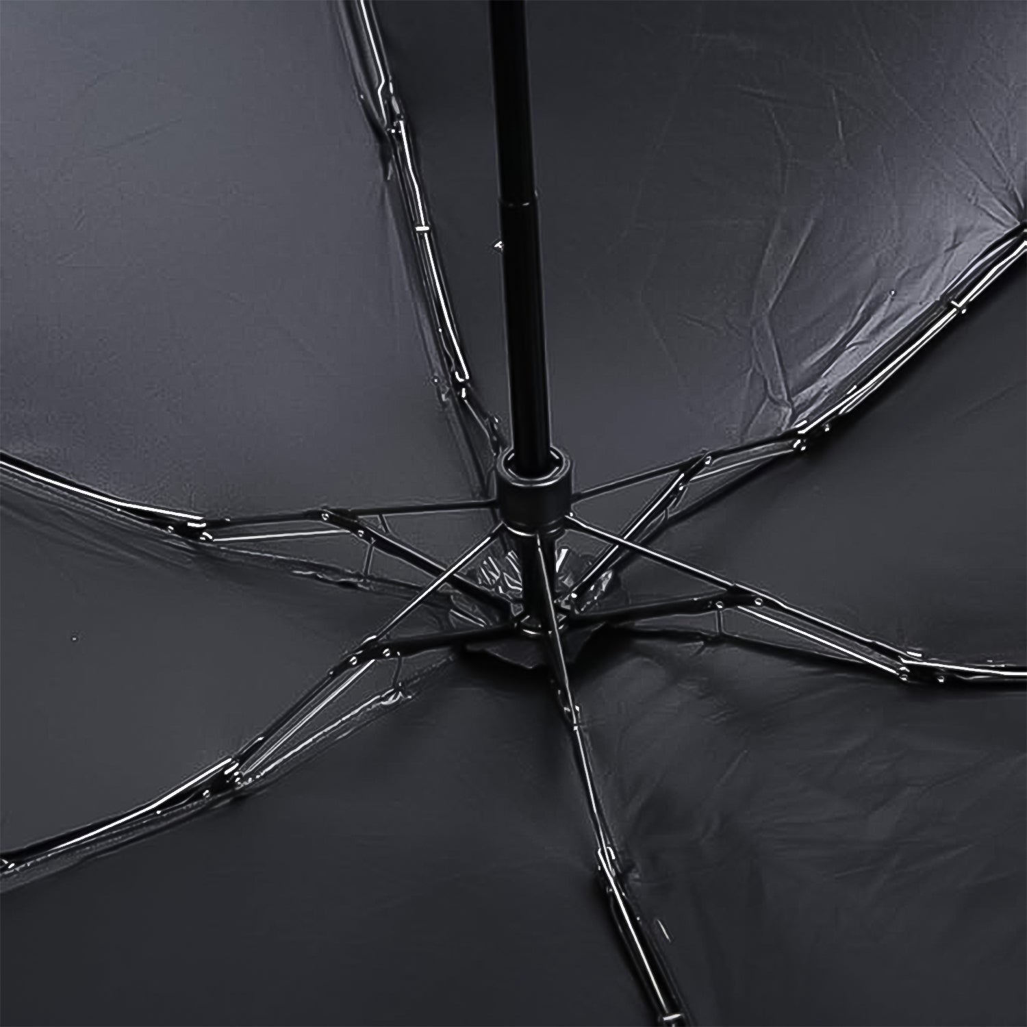 Detailed view of the DrizzlePro compact umbrella's canopy and frame construction.