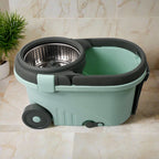 The Ganesh Spin Mop bucket with easy-to-move wheels and a puller handle for convenient transport.