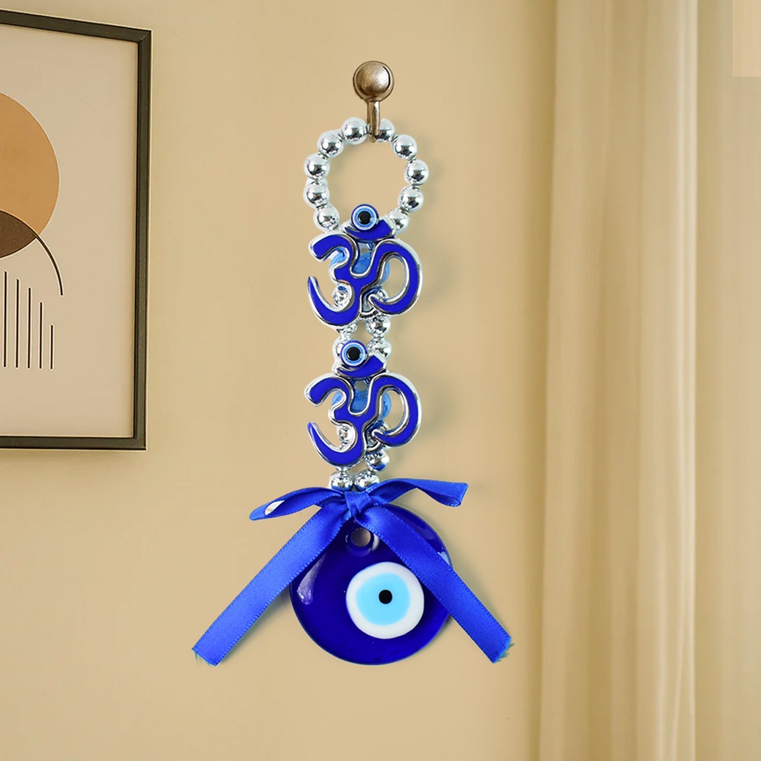 Detailed view of double OM evil eye hanging with beads and ribbon
