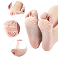 A person's foot wearing a clear silicone tiptoe protector for forefoot cushioning and pain relief.