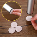 A stack of self-adhesive round cork coasters on a wooden surface, ready for various craft projects.