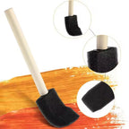 Foam paint brush applying finish on smooth wooden surface