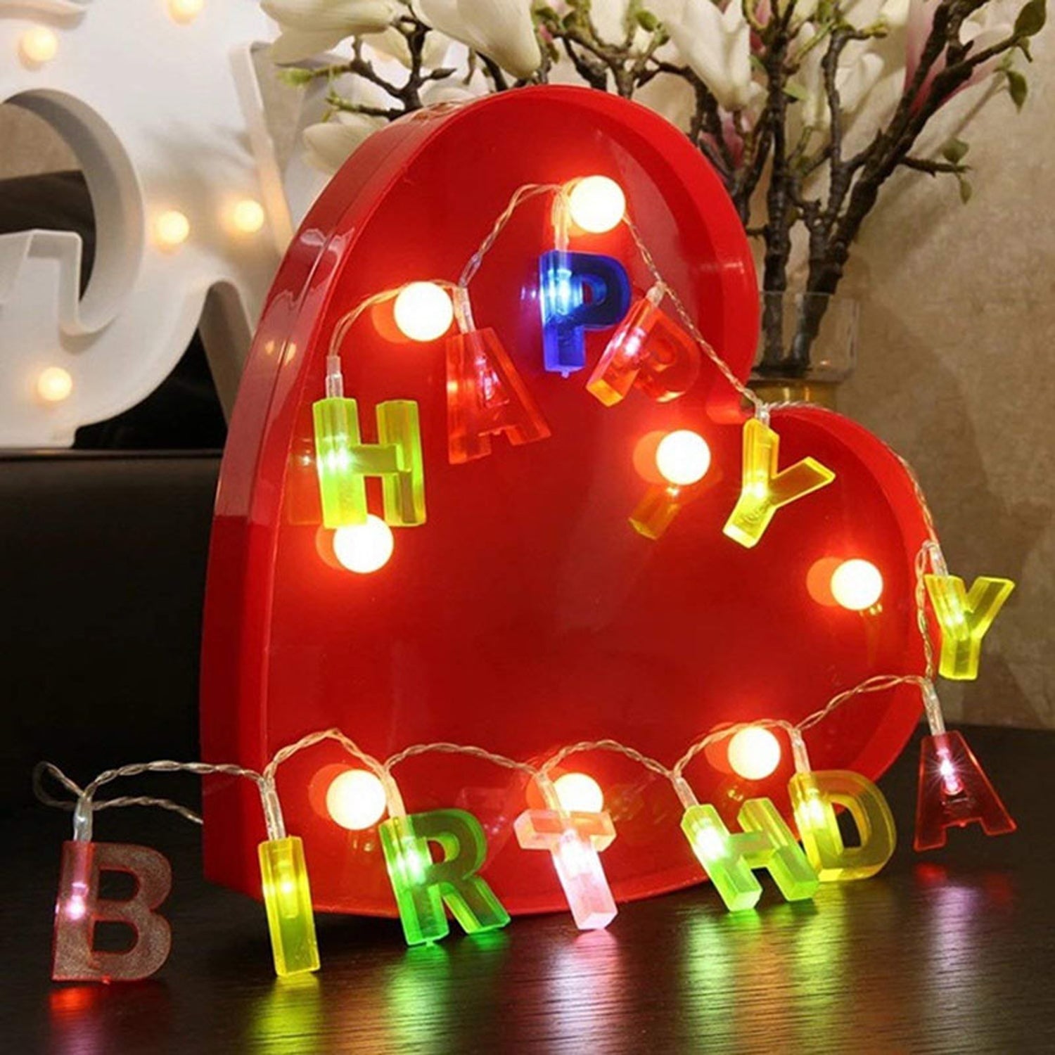 Flexible Happy Birthday LED battery string lights wrapped around furniture