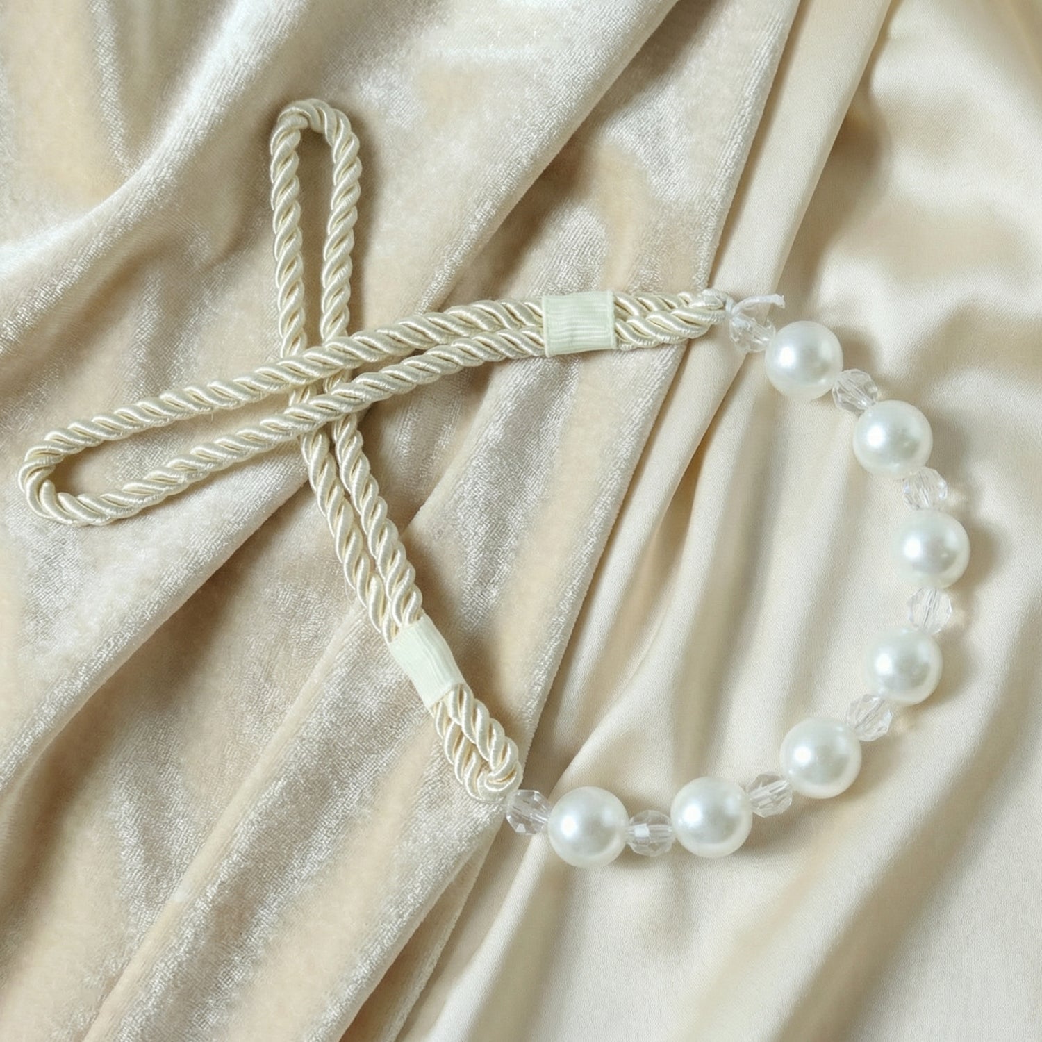 Stylish window drapery tieback featuring pearl beads