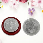 Side view of the round Ganesh coin, highlighting its silver-colored finish.