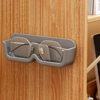 Compact eyewear organizer mounted on wall holding sunglasses
