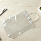 Transparent PVC carry bag 22 x 16 cm showing handle and button closure