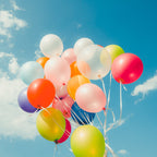 A festive display of multicolored latex balloons for a birthday party.