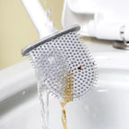 Silicone toilet brush with holder mounted on a clean bathroom wall.