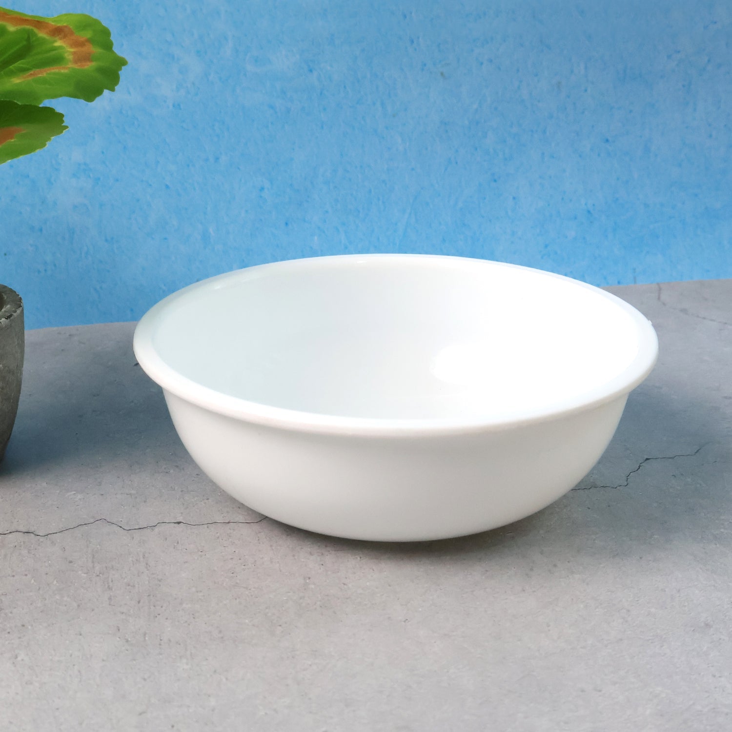 Plastic serving bowl 6 inch with deep round white design on kitchen counter