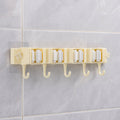 Self-adhesive broom and mop holder rack mounted on wall with utility hooks