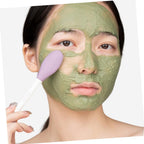 The silicone mask applicator brush displayed with a tube of face mask product.