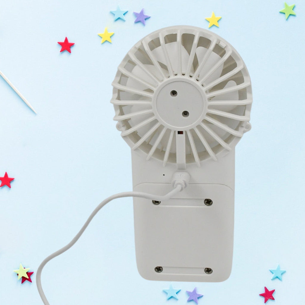 Handheld fan shown with its charging port and a detachable base for desktop use.