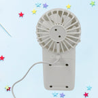 Handheld fan shown with its charging port and a detachable base for desktop use.