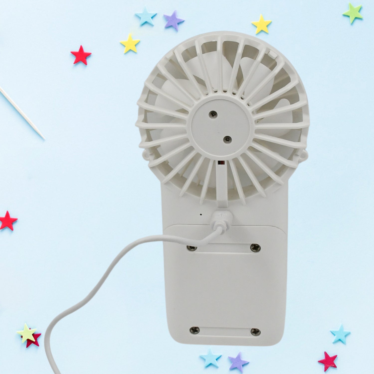 Handheld fan shown with its charging port and a detachable base for desktop use.