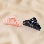 Hair claw clip showcasing sturdy spring-loaded plastic grip for secure hold