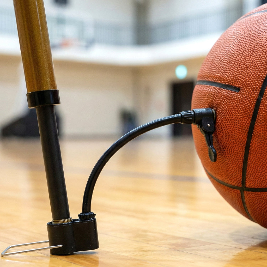 A user easily inflates a basketball using the portable Mini Hand Air Pump with its attached needle.