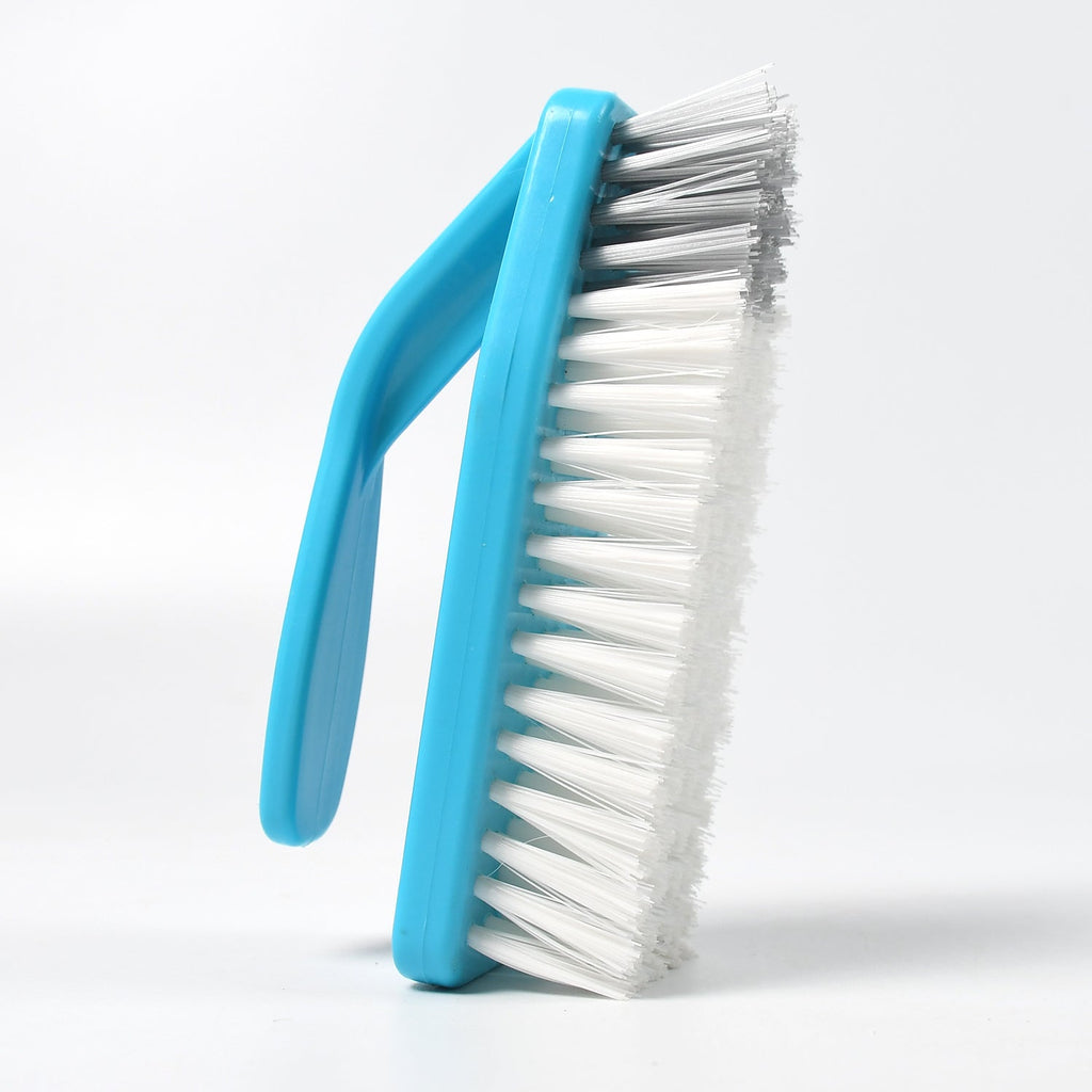 Kitchen cleaning tool, a versatile brush tackling dirt in a sink.