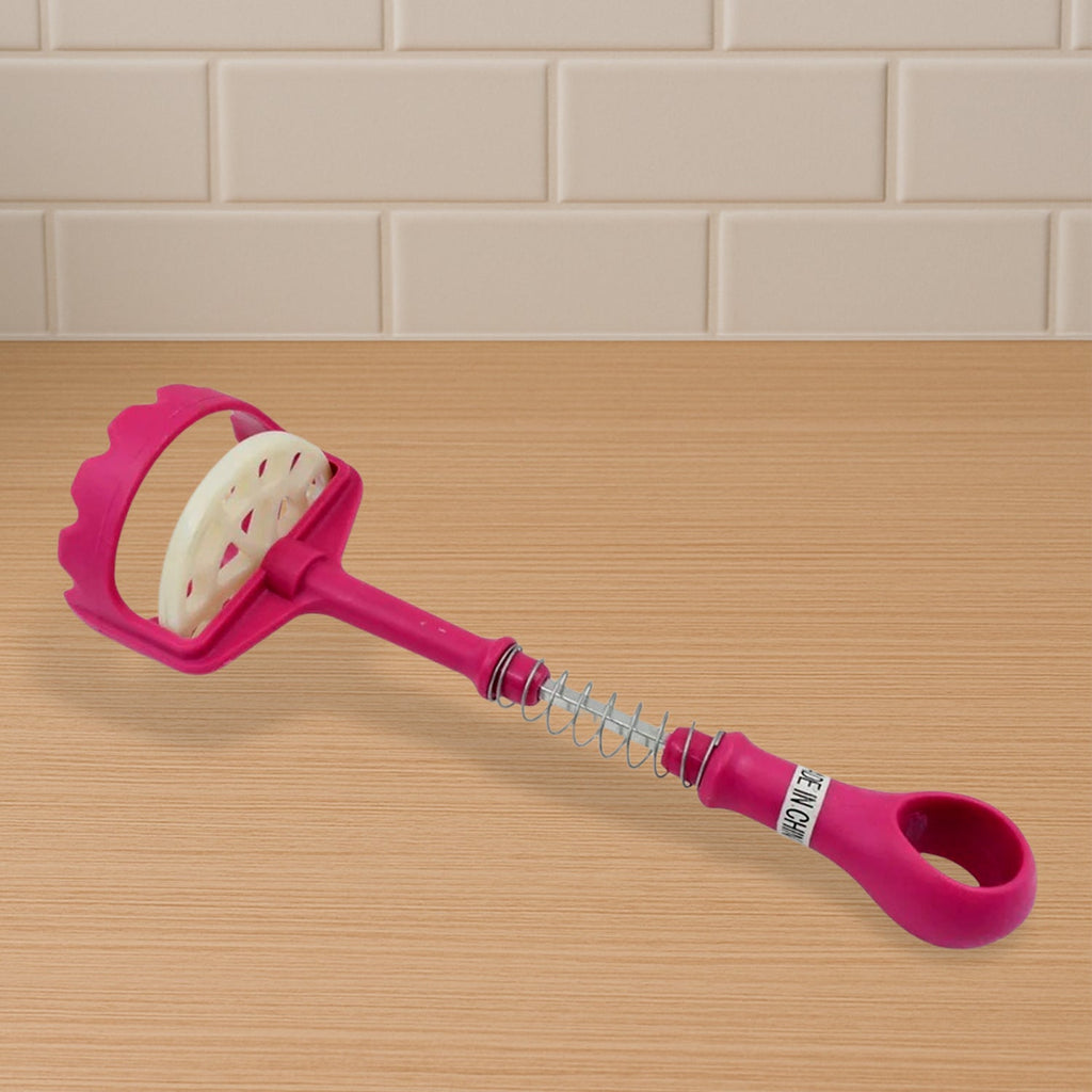 User mashing boiled potatoes for a creamy texture.