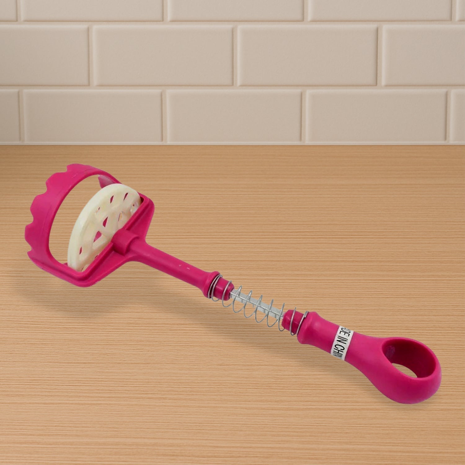 User mashing boiled potatoes for a creamy texture.