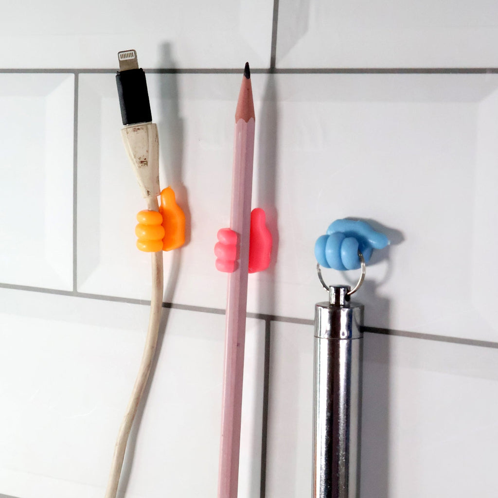 Various small items like socks and innerwear clipped onto mini utility hangers on a drying line.
